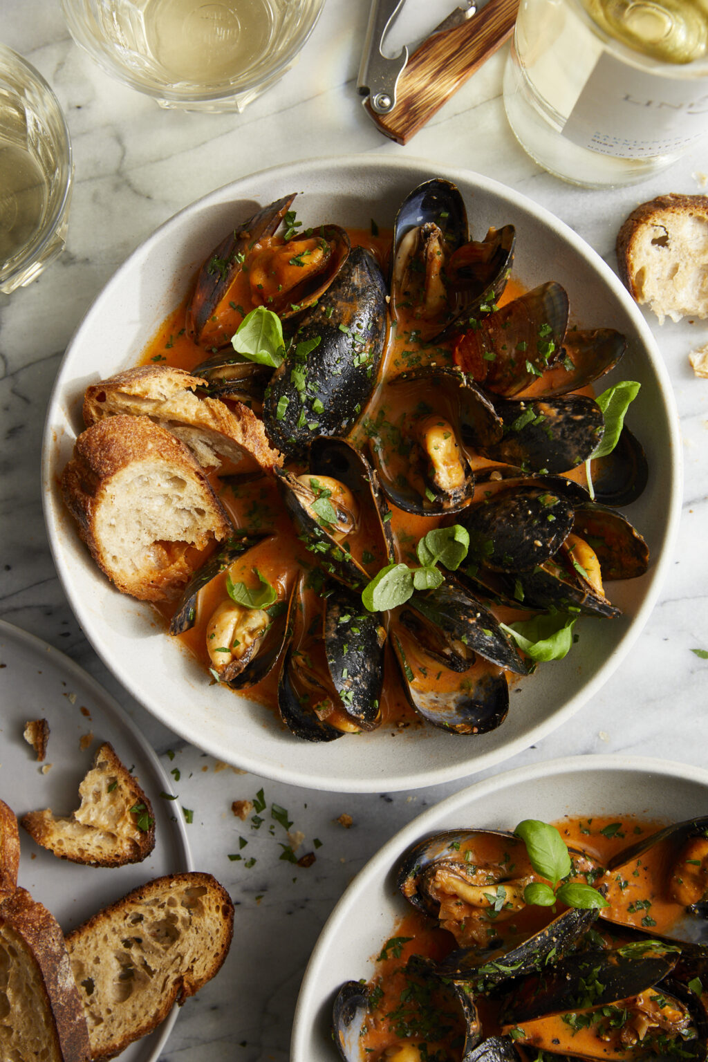 Steamed Mussels in Tomato Cream Sauce—Quick to cook, oh-so-perfect mussels in the best cream sauce ever. Serve with a baguette for dipping!